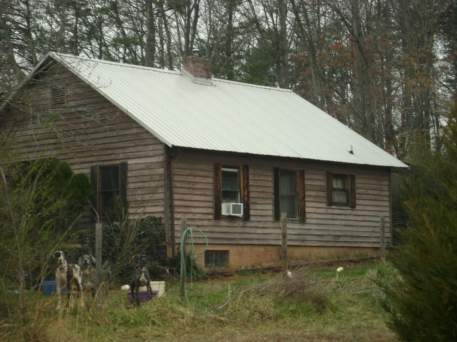 White metal roof on an old wood sided farmhouse, from a Metal Roof Installation job in Thousand Palms
